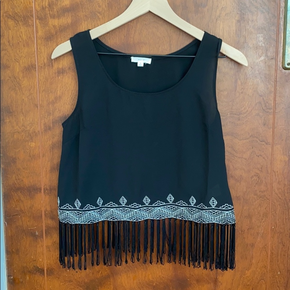Cropped top with fringe, boho vibes.